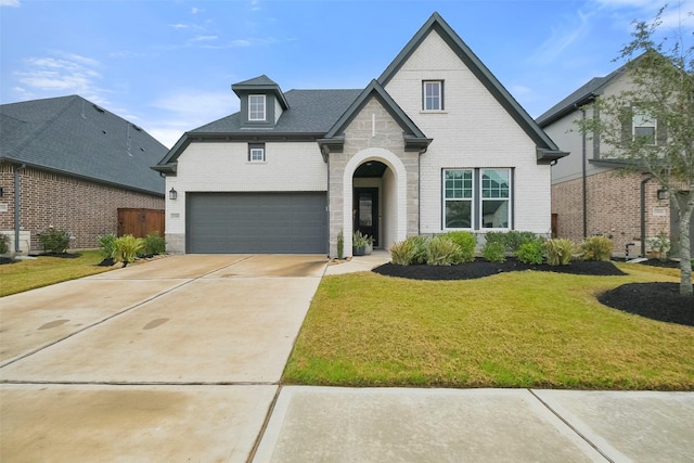 view of front of home featuring a garage and a front yard