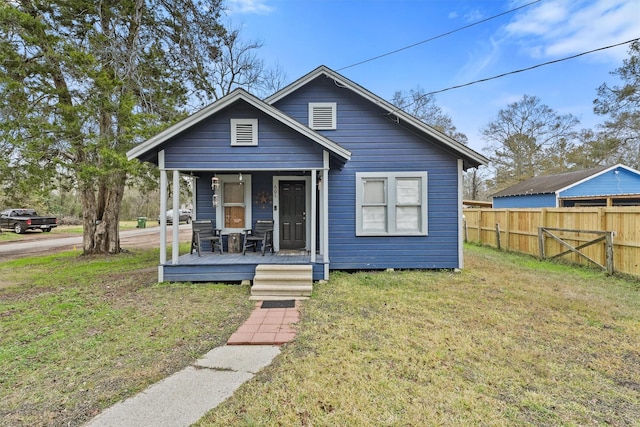 bungalow-style home with a porch and a front yard