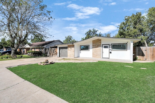 single story home with a garage and a front lawn