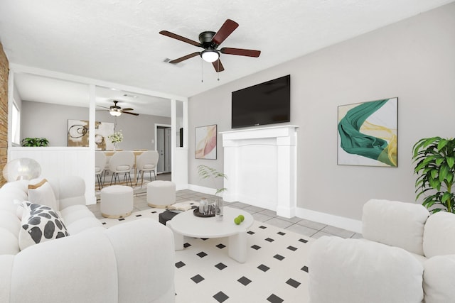 tiled living room featuring ceiling fan