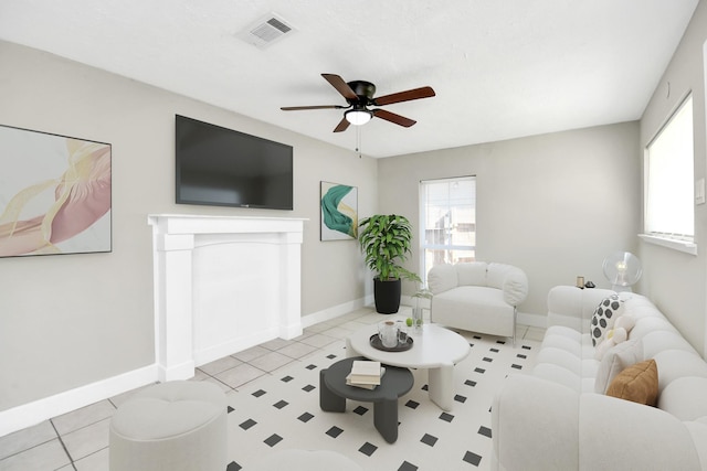 tiled living room featuring ceiling fan