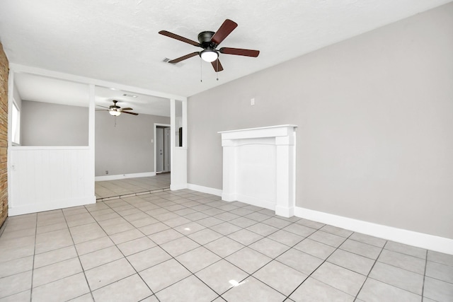 empty room with light tile patterned floors and ceiling fan