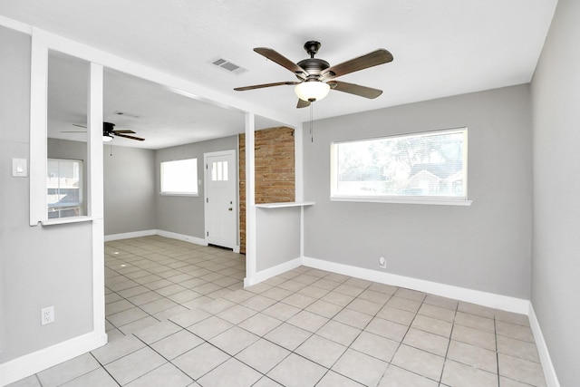 empty room featuring light tile patterned floors and ceiling fan