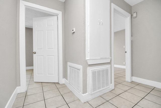 corridor featuring light tile patterned flooring