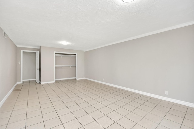 unfurnished bedroom featuring ornamental molding, a closet, and a textured ceiling