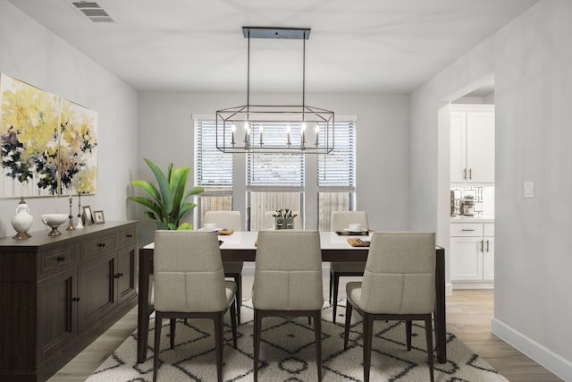 dining room featuring light hardwood / wood-style floors and a notable chandelier