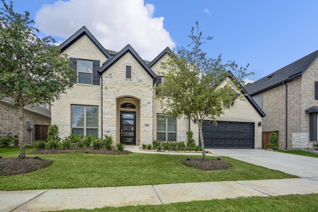 french provincial home featuring a garage and a front lawn