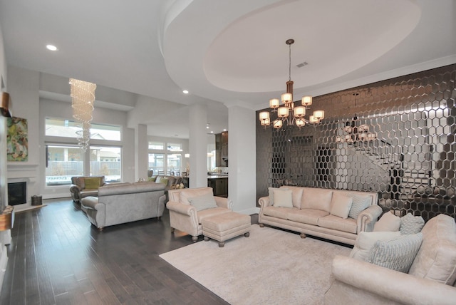 living room with hardwood / wood-style floors, a chandelier, and a tray ceiling