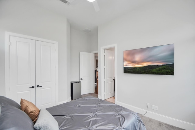 carpeted bedroom featuring ceiling fan, lofted ceiling, and a closet