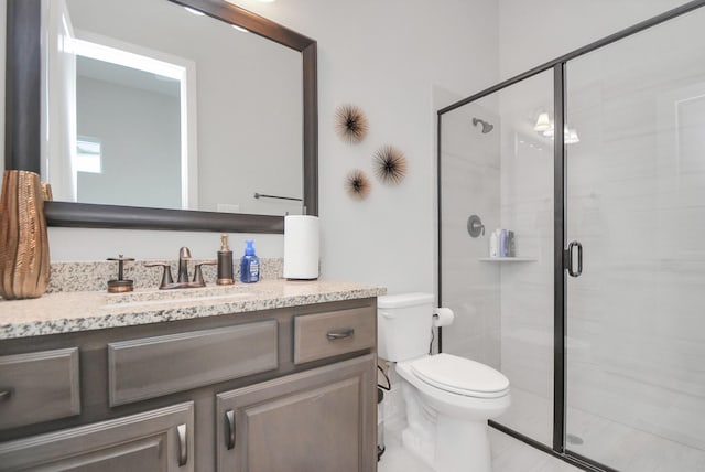 bathroom with vanity, toilet, and walk in shower