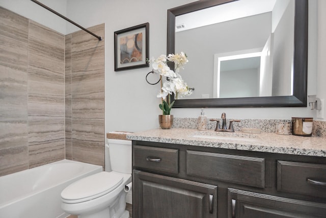 full bathroom with tiled shower / bath combo, vanity, and toilet