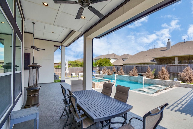 view of patio / terrace featuring ceiling fan and a fenced in pool