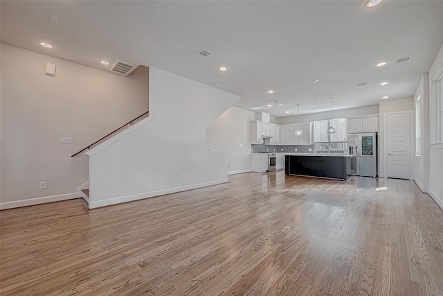 unfurnished living room with light hardwood / wood-style floors