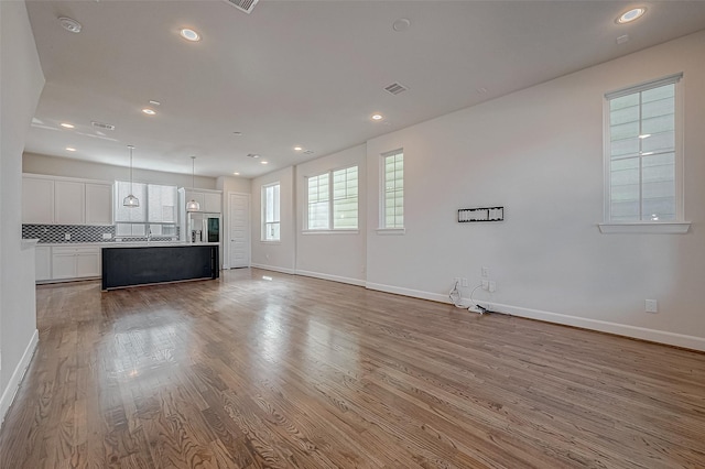 unfurnished living room featuring light hardwood / wood-style floors