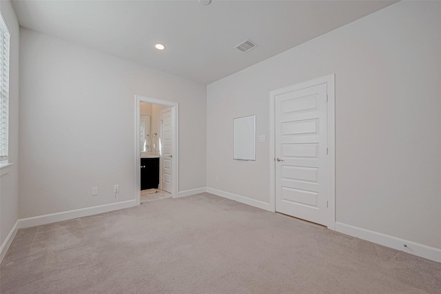 empty room featuring light colored carpet