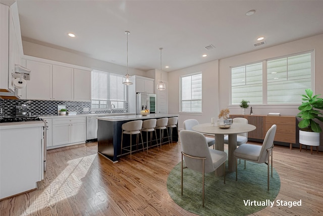 dining space featuring sink and light hardwood / wood-style flooring