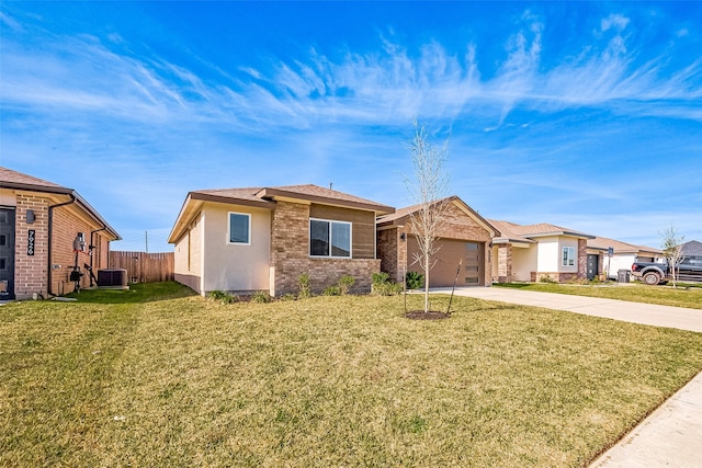 single story home featuring a garage, a front yard, and central air condition unit