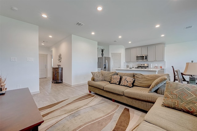 living room with light hardwood / wood-style flooring