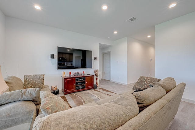 living room with light hardwood / wood-style flooring