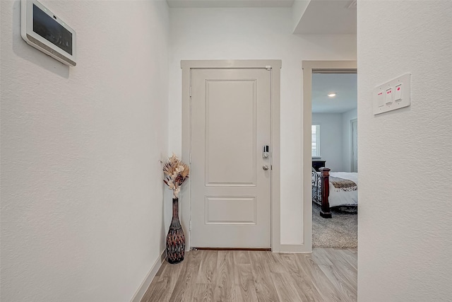 hall with light hardwood / wood-style floors