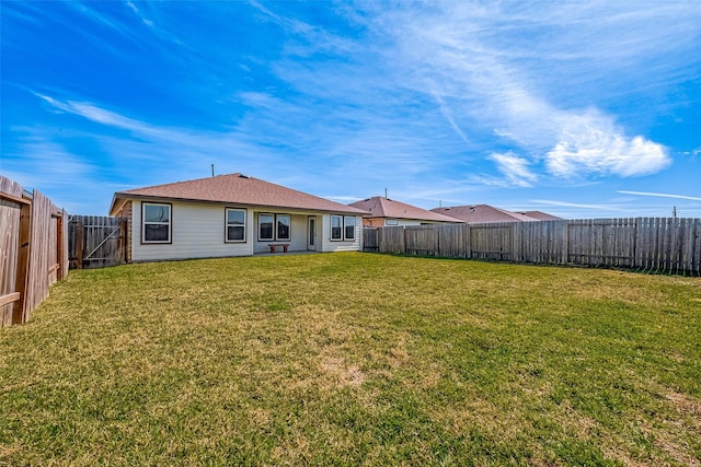 back of house featuring a yard