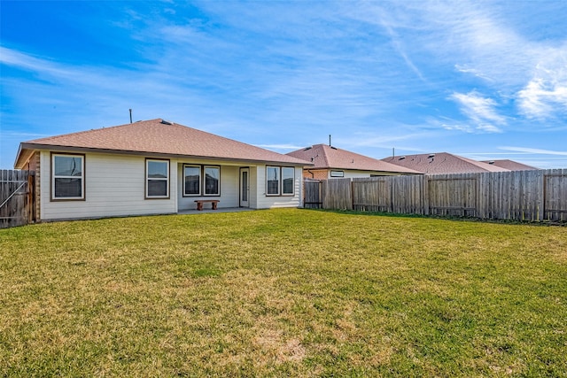 back of house with a yard