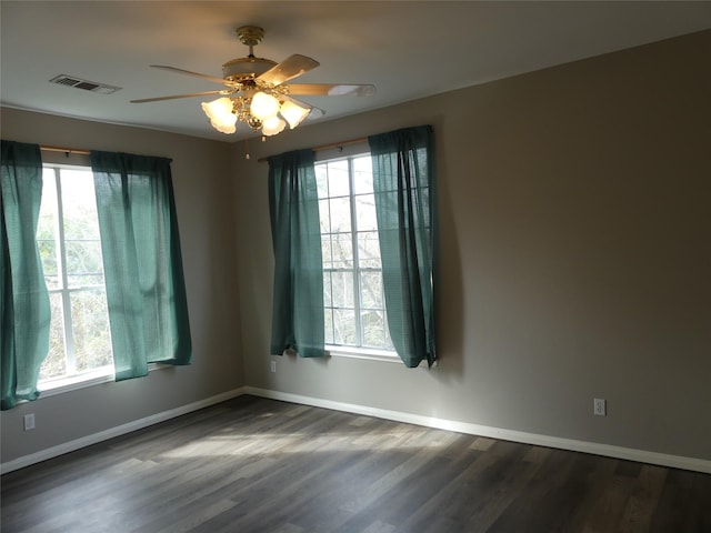 empty room featuring dark wood-type flooring and ceiling fan