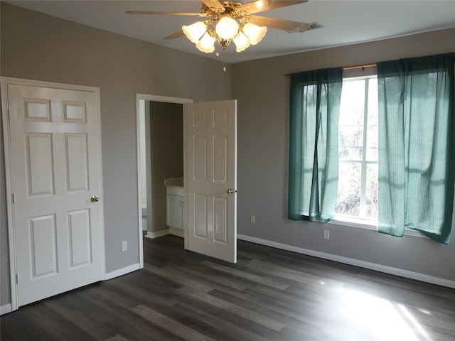 unfurnished bedroom with dark hardwood / wood-style floors and ceiling fan