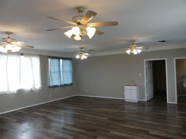 spare room featuring crown molding and dark wood-type flooring