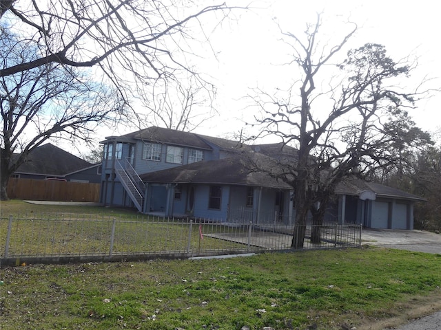 view of front facade with a garage and a front lawn