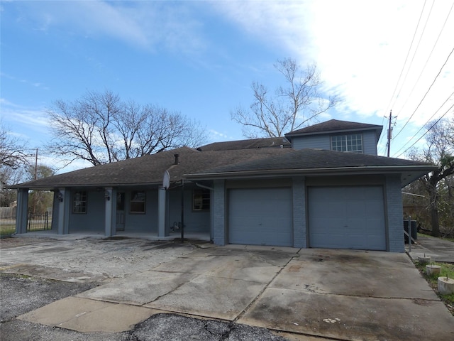 view of front of property with a garage and central AC unit