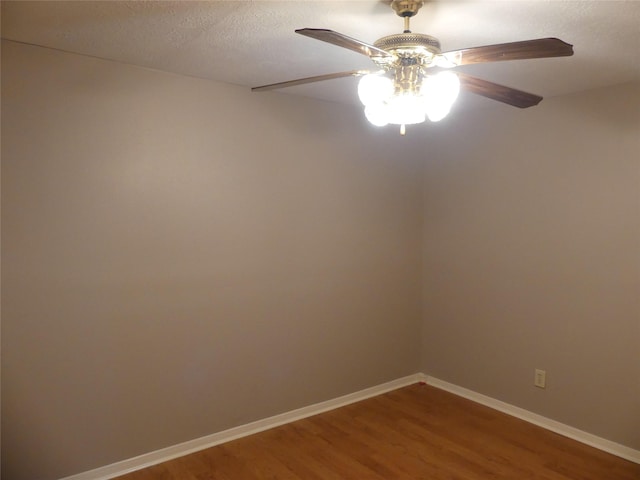 empty room featuring hardwood / wood-style flooring, ceiling fan, and a textured ceiling