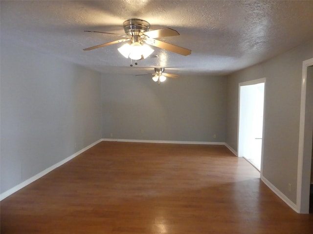 unfurnished room featuring ceiling fan, wood-type flooring, and a textured ceiling