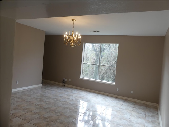 unfurnished room featuring a notable chandelier