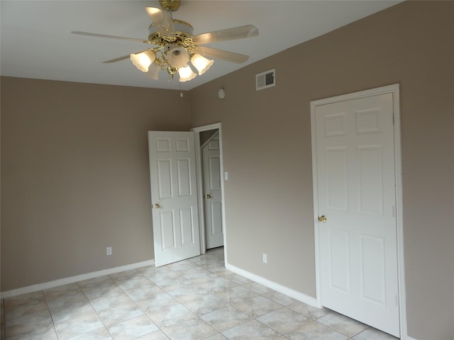 unfurnished bedroom featuring light tile patterned floors and ceiling fan