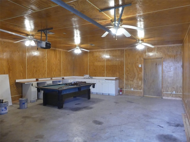 garage with a garage door opener, wood ceiling, and wooden walls