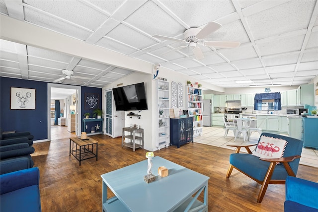 living room featuring hardwood / wood-style floors and ceiling fan