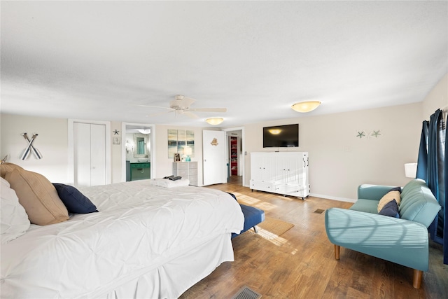 bedroom with wood-type flooring, ceiling fan, and a closet