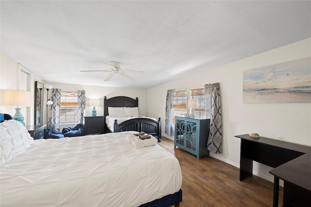 bedroom with multiple windows, a textured ceiling, dark wood-type flooring, and ceiling fan