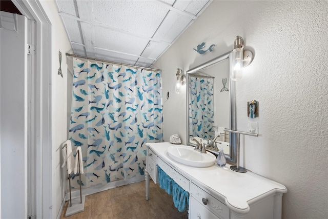 bathroom with vanity, a paneled ceiling, and shower / bathtub combination with curtain