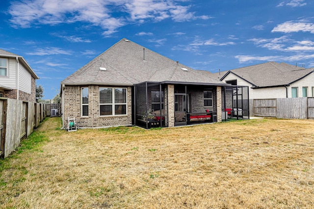 rear view of property with a yard