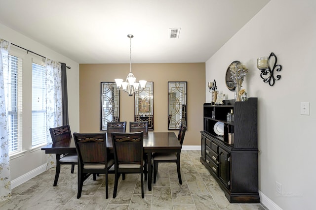 dining space with a notable chandelier