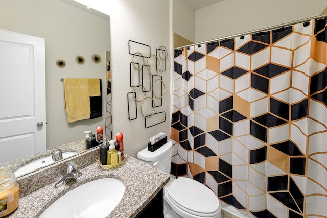 bathroom featuring vanity, toilet, and walk in shower