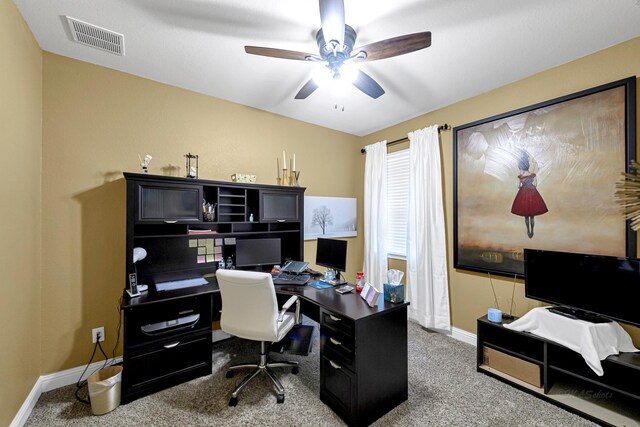 carpeted office space with ceiling fan