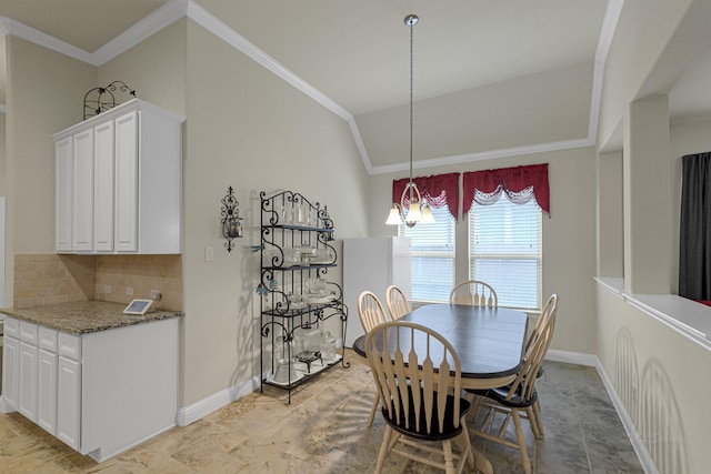 dining space featuring ornamental molding, lofted ceiling, and an inviting chandelier