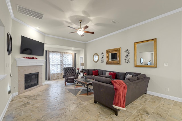 living room with a fireplace, ornamental molding, and ceiling fan