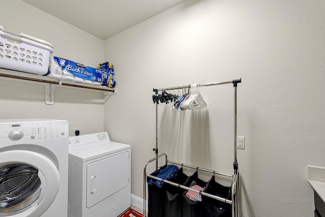 clothes washing area featuring independent washer and dryer