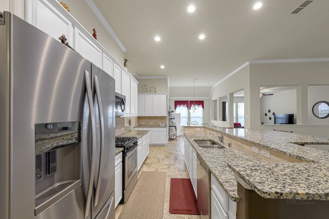 kitchen with sink, white cabinetry, pendant lighting, stainless steel appliances, and a large island