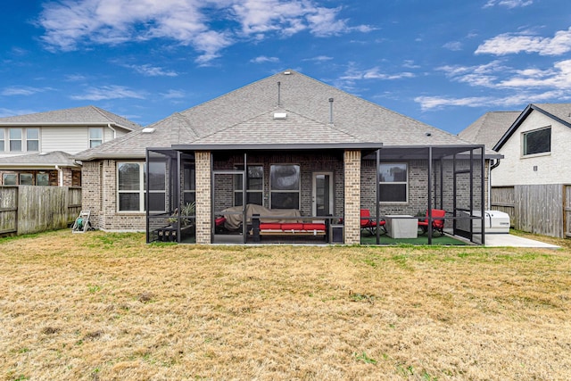 back of house with a sunroom, a yard, and a patio