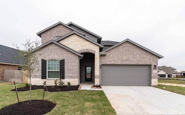 view of front of house featuring a garage, a front lawn, and brick siding